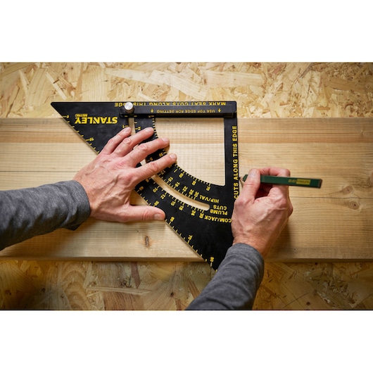 Photo of STANLEY STHT46054-0 square ruler used to mark angles on wood surface, top-down view.