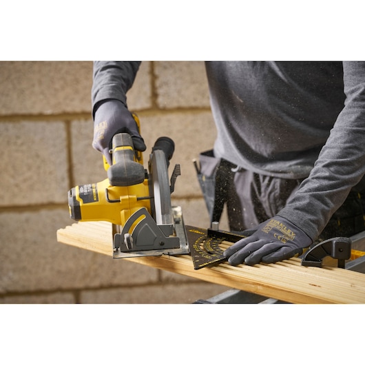 STANLEY STHT46056-0 photography, speed square for measuring and marking wood, shown in use during cutting.