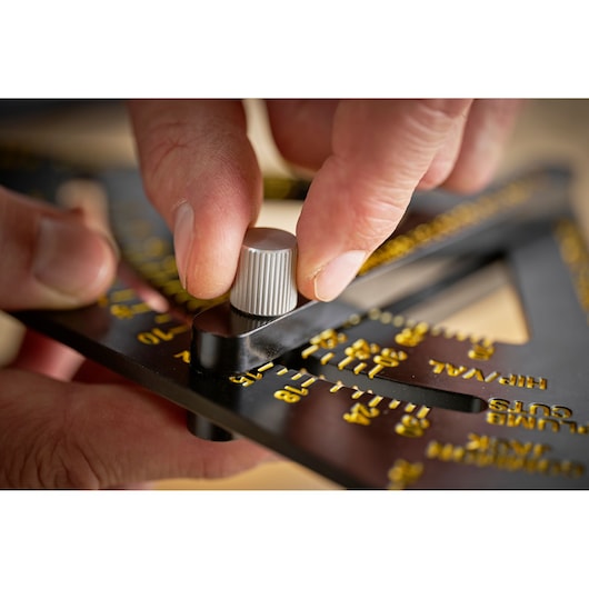 STANLEY STHT46056-0 photography of angle finder tool with yellow markings being adjusted by hand.