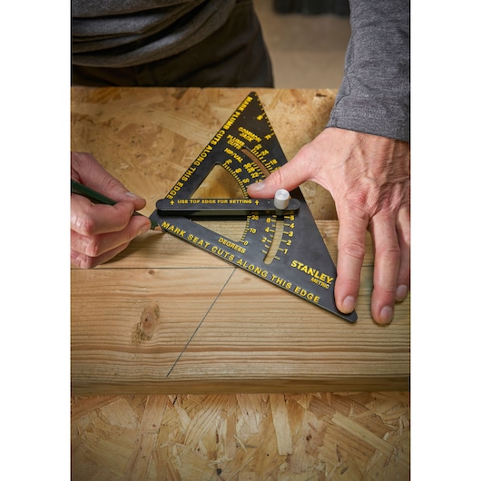 Photo of STANLEY STHT46056-0 metric square tool being used to mark angles on wood.