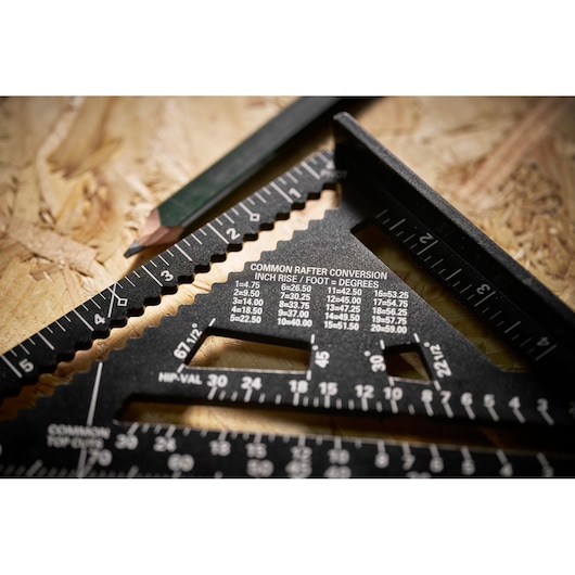 STANLEY STHT46104-0 photography of a black rafter square with conversion markings and a pencil on wood.