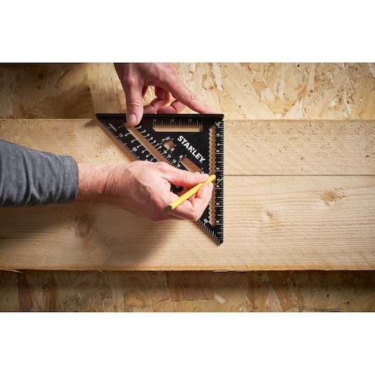 Stanley STHT46104-0 photography of black rafter square used to mark wood with a pencil.