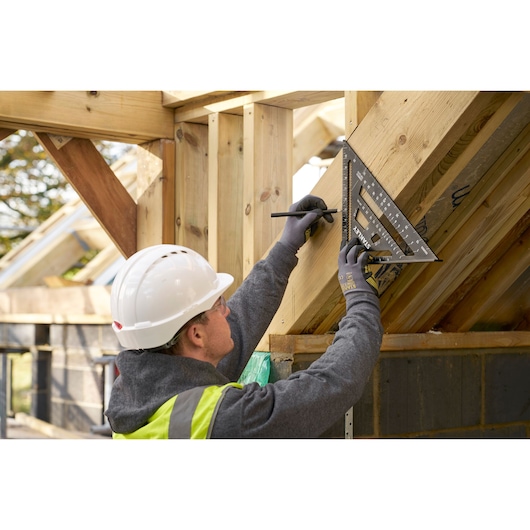 STANLEY STHT46105-0 rafter square used to mark timber angle on construction site.