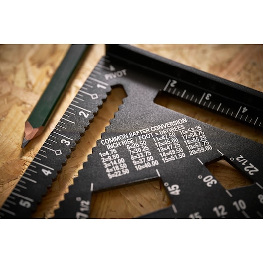 Photo of STANLEY STHT46105-0 photography showing a black rafter square with printed conversion chart and ruler.