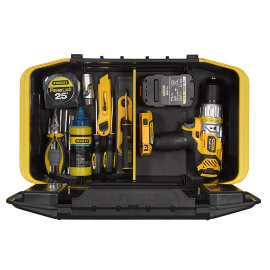 Stanley yellow tool box open with assorted hand tools, tape measure, drill, pliers, and accessories neatly arranged.