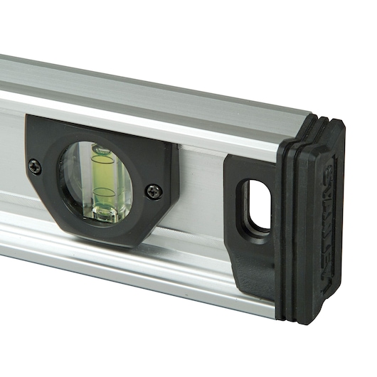 Close-up of a Stanley spirit level with a bubble vial in a silver and black frame.